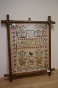 Early 20th Century, needlework, An alphabet sampler illustrated with vases of flowers, initials 'GA'