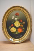20th Century School, oil on canvas, An oval still life arrangement of flowers, signed to the lower
