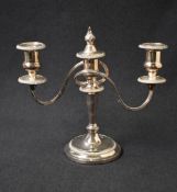 A silver plated two-branch candlestick, of turned and circular form, the central columns flame
