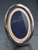An Elizabeth II silver mounted photograph frame, of oval form with stepped mount, marks for