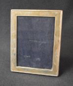 A Queen Eliazbeth II silver mounted wooden photograph frame, of rectangular form having a