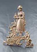 An Edwardian silver place card holder, depicting a woman carrying a tea set surrounded by a floral