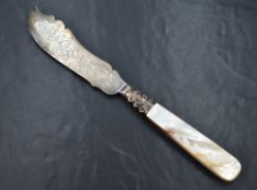 A cased Victorian silver wedding cake knife, having decorative scroll engraving to the silver