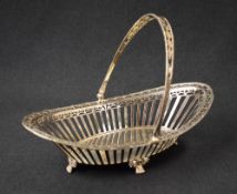 A George V silver basket, of rounded marquise form having decorative pierced sides and handle,