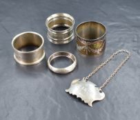 Four silver napkin rings, one having engine turned decoration, one with engraved foliage swags,
