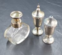A George VI silver pepperette and salt, of traditional form with tapered bodies raised on circular