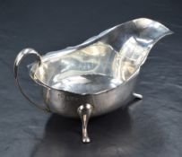 A George V silver sauce or gravy boat, with Chippendale style rim, generous spout opposed by a