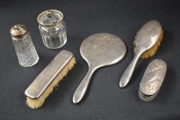An early George V silver mounted vanity set, comprising a hair brush, a clothes brush and a