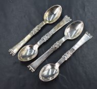 A set of four 20th century Danish white metal teaspoons, having line and foliage motif decoration to