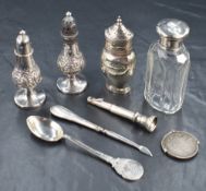 A pair of Victorian silver pepperettes, of traditional form having embossed scroll decoration, marks
