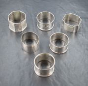 A group of six silver napkin rings, including engine turned decoration, some having monograms,