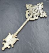 An Ethiopian Orthodox Christian white metal processional cross, of pierced design with engraved