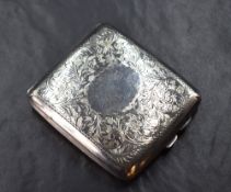 A George V silver cigarette case of hinged rectangular form, having engraved scroll work with a