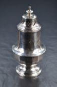 A George V silver sugar caster, having a pierced, finial topped cover over the fluted baluster body,