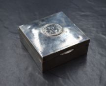 A George V silver cigarette box, of hinged square form with engine turned decoration and central