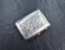 A late Edwardian silver cigarette case of hinged rectangular form curved for the gentleman's pocket,