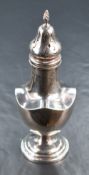 A George V silver sugar caster, of traditional baluster form having a spiral finial and quatrefoil