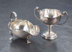 A Victorian silver sauce boat of traditional form, with Chippendale style rim and generous spout