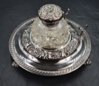 A Walker & Hall silver plated ink stand, the central cut glass silver plate mounted ink well, having