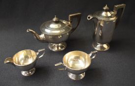 A George VI silver four-piece tea set comprising a tea pot, coffee pot, sugar and cream, all of