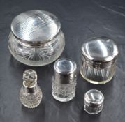 An assortment of silver capped and mounted cut glass dressing table wears, comprising two powder