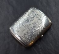 An early Edwardian silver cigarette case of hinged rectangular form curved for the gentleman's