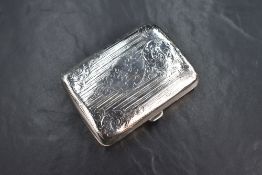 An Edwardian silver cigarette case of hinged rectangular form, having engraved floral scroll and