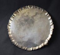 A large Elizabeth II silver salver, having Chippendale inspired rim, raised on four claw feet, marks