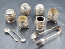 An assortment of Eastern white metal condiment wears, including salts, pepperettes and preserve