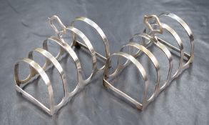 A pair of Elizabeth II silver toast racks, of traditional form with pierced handles, marks for