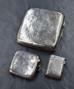 A George V silver cigarette case of hinged square form, having engraved floral scroll decoration