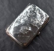 An early George V silver cigarette case of hinged rectangular form, having decorative scroll