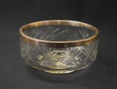 An Edwardian silver mounted cut glass fruit bowl, the glass bowl with star burst cut decoration with