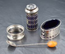 A George V silver salt of oval form, having decorative openwork and engraving with blue glass liner,