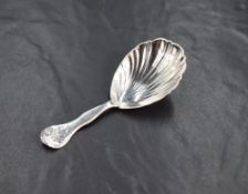 A Victorian silver caddy spoon, of traditional form having a scallop bowl and foliage decoration