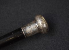 An early 20th century silver mounted walking cane, the dark wood cane with rounded silver mounted