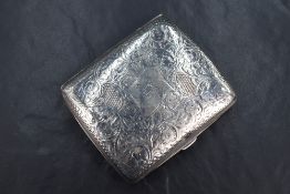 A late Edwardian silver cigarette case of hinged square form curved for the gentlman's pocket,