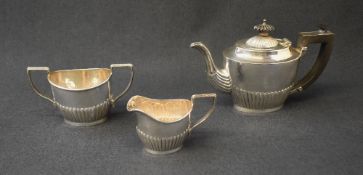 A George V silver three piece tea set, comprising a tea pot, sugar and milk each of oval half-