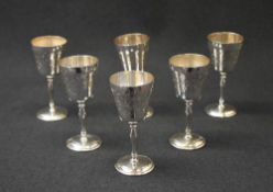 A set of six Elizabeth II silver goblets, of tradition form with decorative scroll engraving with