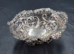 A Victorian silver dish, of oval form having a lobed rim of embossed floral and scroll design,
