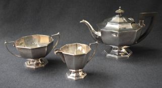 A George VI silver three piece tea set, comprising a tea pot, cream and sugar, having tapered