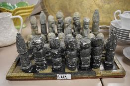An interesting 20th Century East African design chess set, comprising thirty one soapstone carved