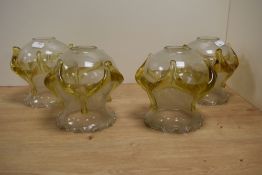 A set of four mid-century amber and clear glass lamp shades, with crimped rim and applied amber