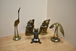 A decorative cast-brass anthropomorphic cat two branch candlestick, formed as a tuxedo wearing cat