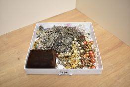 An assortment of costume jewellery, including beaded necklaces, brooches, watch chains and imitation
