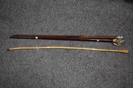 Three walking sticks, one having a carved musketeer figure handle.