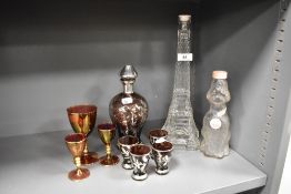 A decorative Continental tinted and silver overlay/lustre glass liqueur decanter and four glasses,