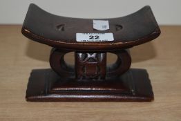 A miniature African carved wood Ashanti stool 8cm x 13cm