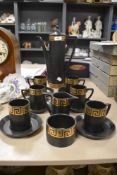 A Portmeirion Pottery black and gold Greek key coffee set, designed by Susan Williams-Ellis,