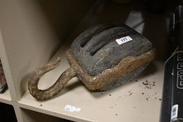 A vintage industrial metal double block pulley.